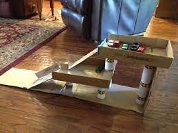 Parking Garage For Kids That I Made Out Of Cardboard Boxes And Paper Towel Toilet Paper Tubes Diy Kids Games Diy For Kids Fun Diys