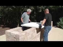Fence pickets are attached around the outside of the bar. How To Build A Concrete Countertop For Your Outdoor Kitchen Youtube