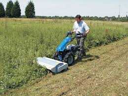 Bcs two wheel tractor with snow plow being used to clear snow from a car park. Bcs 740 Two Wheel Tractor Tractors Wheel Mower
