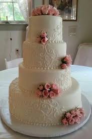 A Four Tier Fondant Wedding Cake With Fresh Roses And Scroll Work Pink Rose Wedding Cake Scroll Wedding Cake Wedding Cakes