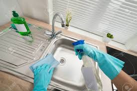 Place a pan or bucket underneath the drain to catch any water or debris that if all of your diy efforts don't work, stoppages in the sink, bathtub, shower and toilets may be covered by an american home shield home service. Person Hands In Blue Glove Cleaning Silver Kitchen Sink Stock Photo Picture And Royalty Free Image Image 39679265