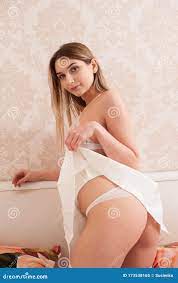 Young Blonde Girl Playfully Posing in Lace Underwear and a Short Dress on  the Bed Stock Image - Image of skirt, hips: 173538165