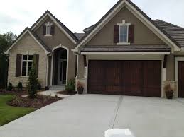 Black And White House With Wood Garage Door Like Exterior Colors Wood Garage Door No Visible Hardware And Wood Shutters Garage Exterior Garage Doors House Exterior