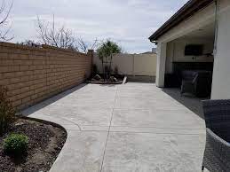 Grey Stamped Concrete Patio Extension With Concrete Retaining Wall Concrete Mccabes Stamped Concrete Patio Patio Stones Concrete Patio