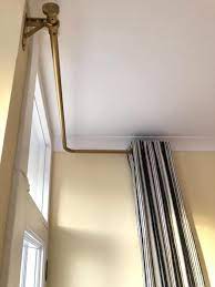 These double drapery rods are dressed in a brushed nickel finish and can accommodate window widths of 72 in. How To Dress Difficult Windows Curtain Poles For Corner Bay Windows Corner Window Treatments Corner Window Curtains Window Treatments Living Room