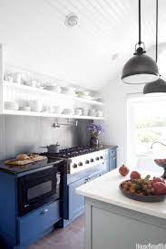 The rustic decor above the stove and tin tiles on the ceiling add retro touches that are complemented by bold blue cabinets. 15 Blue Kitchen Design Ideas Blue Kitchen Walls