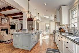 The kitchen enjoys an adjacent breakfast nook and a dining room is just around the corner for larger family gatherings. Kitchen Islands With Columns Designing Idea