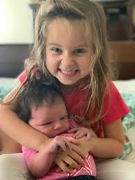 Woman wearing XOXO splatter shirt at Texas Roadhouse