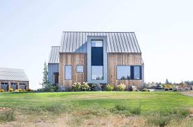 Tall windows are strategically placed around interior spaces to provide optimal views out toward the mountain ranges in the distance and provide natural light to key. Modern Farmhouse