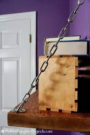 If you want to hang purses off the hanging rod, you can add more eye hooks on the opposite side of the dowel. Diy Rustic Redwood Chain Shelf Diy Hanging Shelves Hanging Shelves Diy Computer Desk Ideas