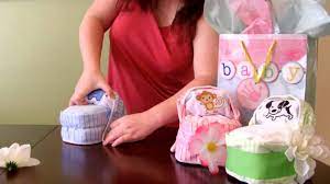 Learn how to make mini diaper cakes, the perfect centerpiece for a gender reveal baby shower. How To Make A Diaper Cake Small Bassinet For Baby Shower Youtube