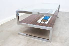 A rectangular table would also work if the sides of the sofa aren't super long (you don't want to leave anyone sitting on the edges of the sides without easy access to a table, afterall). S Shaped Ceramic Tiled Coffee Table From De Nisco 1960s For Sale At Pamono