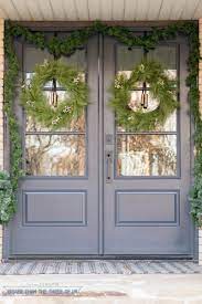 Double Front Door With Cracked Pepper Paint Color Decorated For Christmas W Front Porch Christmas Decor Front Porch Decorating Front Door Christmas Decorations