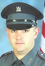 City man held in officer's death