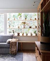 This window plant shelf is super simple… if you don't already have a wide window sill to place your plants on, have a board cut to fit the sill and attach with small nails. Hanging Plant Shelves The Artful Roost
