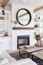 Older houses come filled with surprises. Round Black Mirror On White Brick Fireplace Cottage Living Room