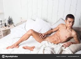 Young handsome man rest in bed. Sexy naked guy is resting Stock Photo by  ©DmitryTkachev 323355316