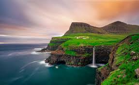 The mulafossure waterfall on a sunny day in the faroe islands. Faroe Islands Photo Tour 2022 Cliffsides Waterfalls