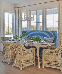 Charming Cottage Dining Room Boasts A Blue Stripe Wingback Settee Placed In Front Of Windows Dre South Carolina Beach Houses Cottage Dining Rooms Cottage Style