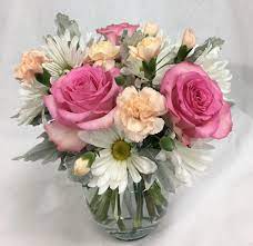 Pink Standard Roses White Chrysanthemum Daisies Light Orange Pixie Carnations And Dusty Miller In Flower Arrangements Pink And White Flowers Standard Roses