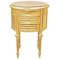 This nightstand can take it with style. Nightstand Bedside Drum Oval Gold Wood With 3 Drawers And Black Marble
