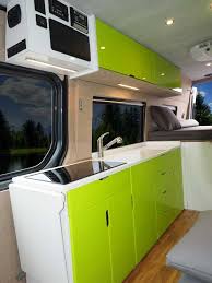 The Modern Kitchen With A Bright Green And White Color Scheme Inside A Custom Sportsmobile Van Conversion Van