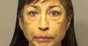 Woman charged with pointing gun at vehicle with children