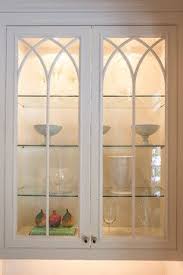 The Kitchen Cabinets Have Glass Doors And Interior Lighting Displaying The Objects Insi Glass Kitchen Cabinets Glass Cabinet Doors Glass Kitchen Cabinet Doors