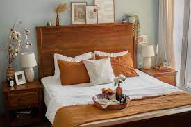 Piles of white linens soften an ornate vintage wood bed frame. 10 Tips For Decorating A Beautiful Bedroom