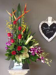 A Large Tropical Arrangement With Roses Orchids Anthurium Lillies And Hel Church Flower Arrangements Tropical Flower Arrangements Flower Arrangements Simple