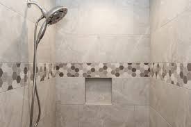Gray Tiled Shower With Hexagon Tile Accent Strip Shower Tile Tile Bathroom Gray Shower Tile