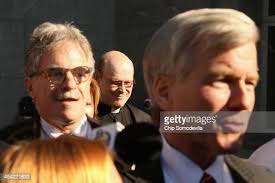 Rev. Wayne Ball of St. Patrick's Catholic Church accompanies former... News  Photo