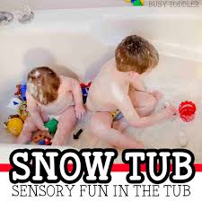 Little baby washing with a bubbles in bath in a hat. Snow Tub Bath Time Activity Busy Toddler