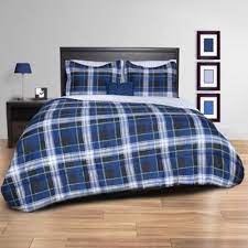 A complete sheet set features a contrasting navy flange that adds a bold accent to the sheet set, while a decorative pillow and navy bed skirt provides the finishing touches. Striking Plaid Comforter Set Bed Bath Beyond