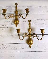 Brass taper candle holders elevate whatever table, sideboard or shelf they're placed on. Vintage Brass Wall Sconces Made In England English Brass Etsy Antique Brass Candle Holders Wall Lights Antique Brass Traditional Wall Lighting