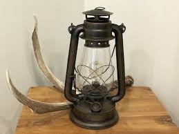 Place matching table lamps on either side of the bed atop stylish nightstands in a master bedroom, perch a short lamp on a side table next to a plush leather sofa, or welcome guests with a small lamp in the front foyer. Lantern Table Lamp Medium Patina Finish Dimmable Muskoka Lifestyle Products