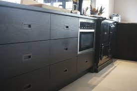 Stained Black Oak With Recessed Bronze Handles Black Kitchens Oak Cabinets Staining Cabinets