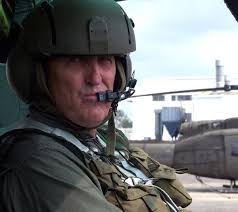 CHIEF Warrant Officer 5 Edwin G. Thrash, of Saucier, Mississippi, pauses  from conducting the post-flight checklist in his UH-1 Huey helicopter after  flying a reconnaissance mission over the coastal counties