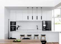 The dark colour fits well in contrast with the dark wood cabinets, floors, and countertops of an the kitchen floors: Black Kitchen Appliances Dark And Bold Additions For Every Kitchen