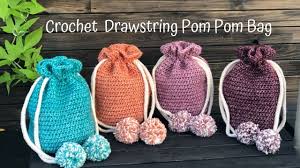 The challenge was to create something from a pack of lion free pattern to crochet handmade handbag with drawstring. Crochet Drawstring Bag Pattern With Pom Poms Knitcroaddict