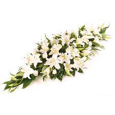 Burst of colour casket spray. White Lilly Flowers Arranged In Funeral Casket Spray Delivered In The Uk