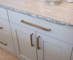 White kitchen cabinets with gold hardware. How To Warm Up A White Space Jm Kitchen And Bath Design