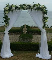 Up Close White Wood Wedding Arch With Sheer Curtains Greenery And White Flowers Wedding Arch Diy Wedding Backdrop Wood Wedding Arches