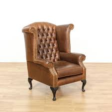 This Wingback Armchair Is Upholstered In A Durable Faux Brown Leather Vinyl With A Shiny Finish This Tradi Armchair Wingback Armchair Traditional Accent Chair