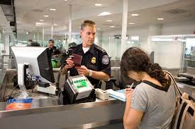 U.s. Customs And Border Protection (Cbp) Agent Processes A Passenger Into  The U.s. At An Airport | Homeland Security