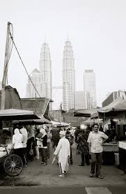The Petronas Towers Looming Over The Malay Area Of Kampung Baru Kuala Lumpur Malaysia Kampung Baru Is A Malay Encla Kampung Baru Travel Around Travel Dreams