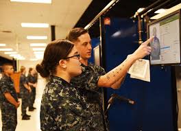 Gunner's Mate 2nd Class Clint Craig reviews a shot pattern