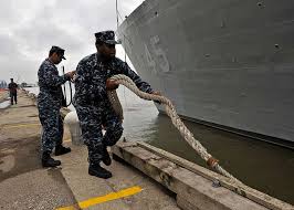 Master-at-Arms 3rd Class Ryan Marshall, right, assigned