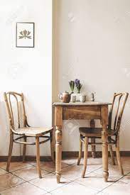 Metal kitchen table legs wrought iron kitchen table industrial kitchen table small images of industrial workstation. Vintage Interior Design Of Kitchen Space With Small Table Against White Wall With Simple Chairs And Plant Decorations Minimalistic Concept Of Kitchen Space Stock Photo Picture And Royalty Free Image Image 107550638