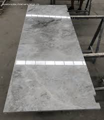 Thin sheets of marble are molded around a wood base to create the look of a solid piece. China Van Gogh Abba White Grey Marble Dresser Desk For Hotel Bedroom Furniture Cabinet Tops Design China Countertop Table Top